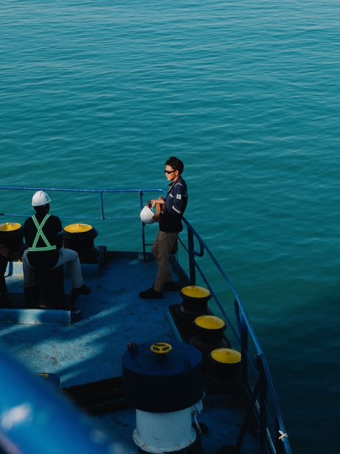 cargo ship crew on deck at sea