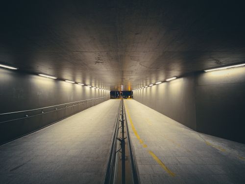 Free Symmetrical view of a lit modern urban tunnel in Budapest, Hungary, at night. Stock Photo