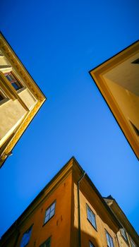 Vibrant view of historic Stockholm buildings against a clear blue sky.