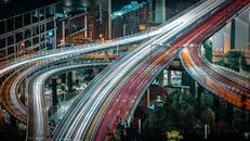Cars driving on urban highway in evening
