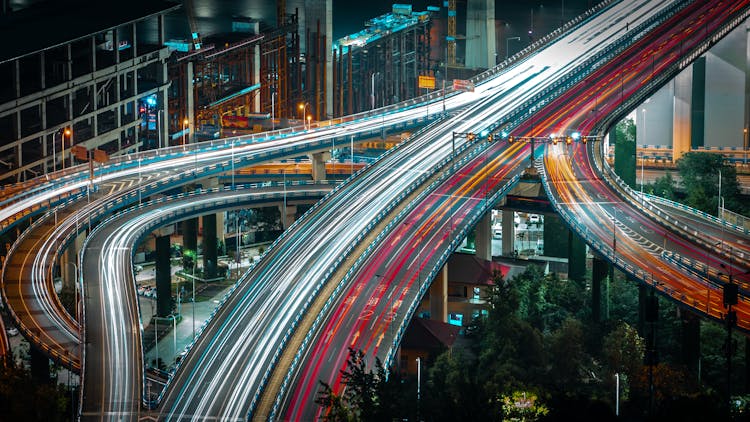 Cars Driving On Urban Highway In Evening