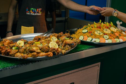 Delicious Filipino street food displayed in a bustling outdoor market in the Philippines.
