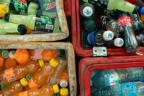 Free Vibrant photo of various chilled soft drinks in outdoor coolers, perfect for a hot day. Stock Photo