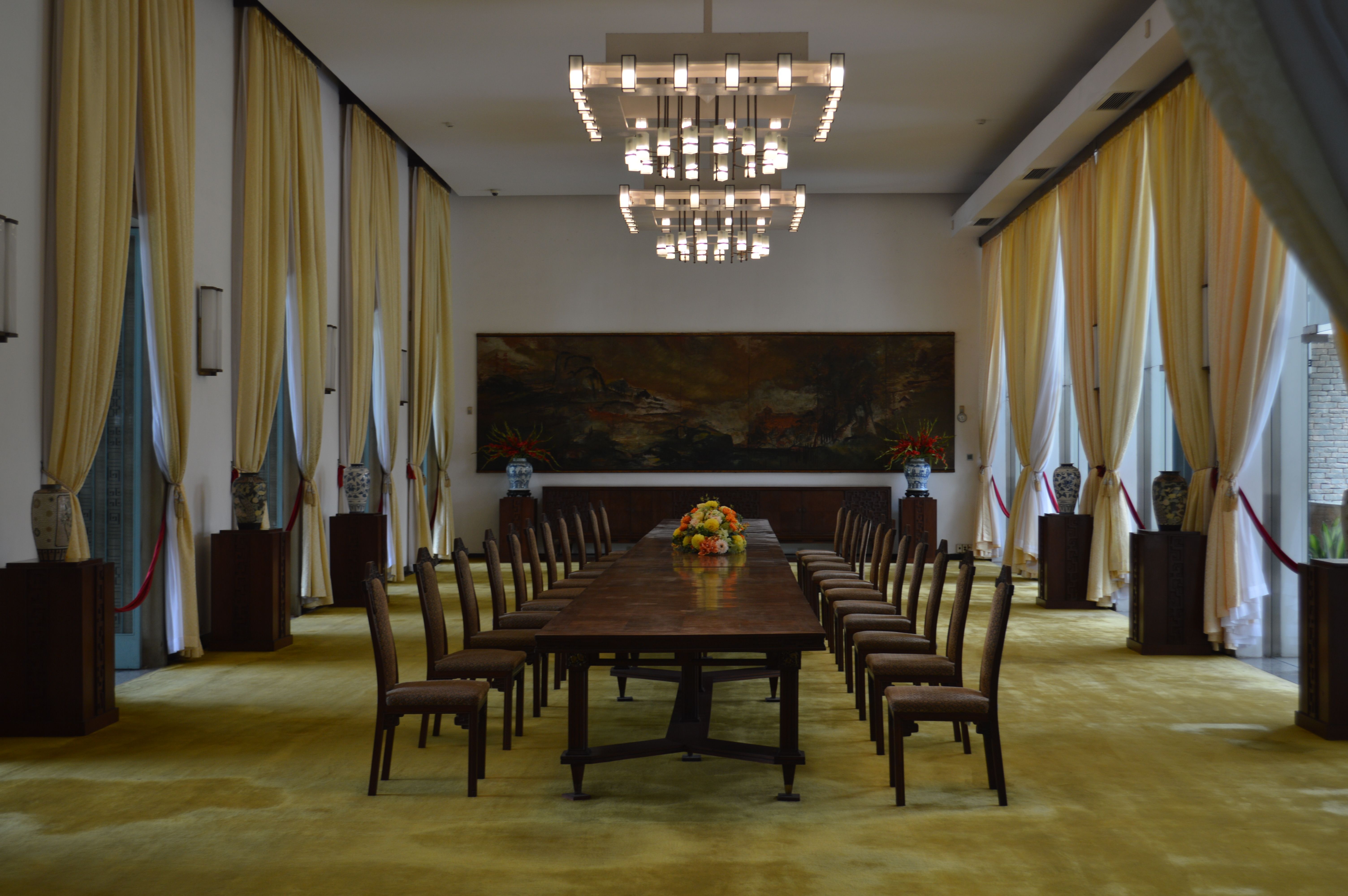 A sophisticated glass-walled boardroom overlooking a global financial district at sunset, symbolizing strategic business consolidation.