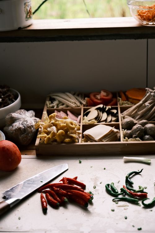 Free A variety of fresh vegetables and spices on a kitchen counter, ready for cooking preparation. Stock Photo