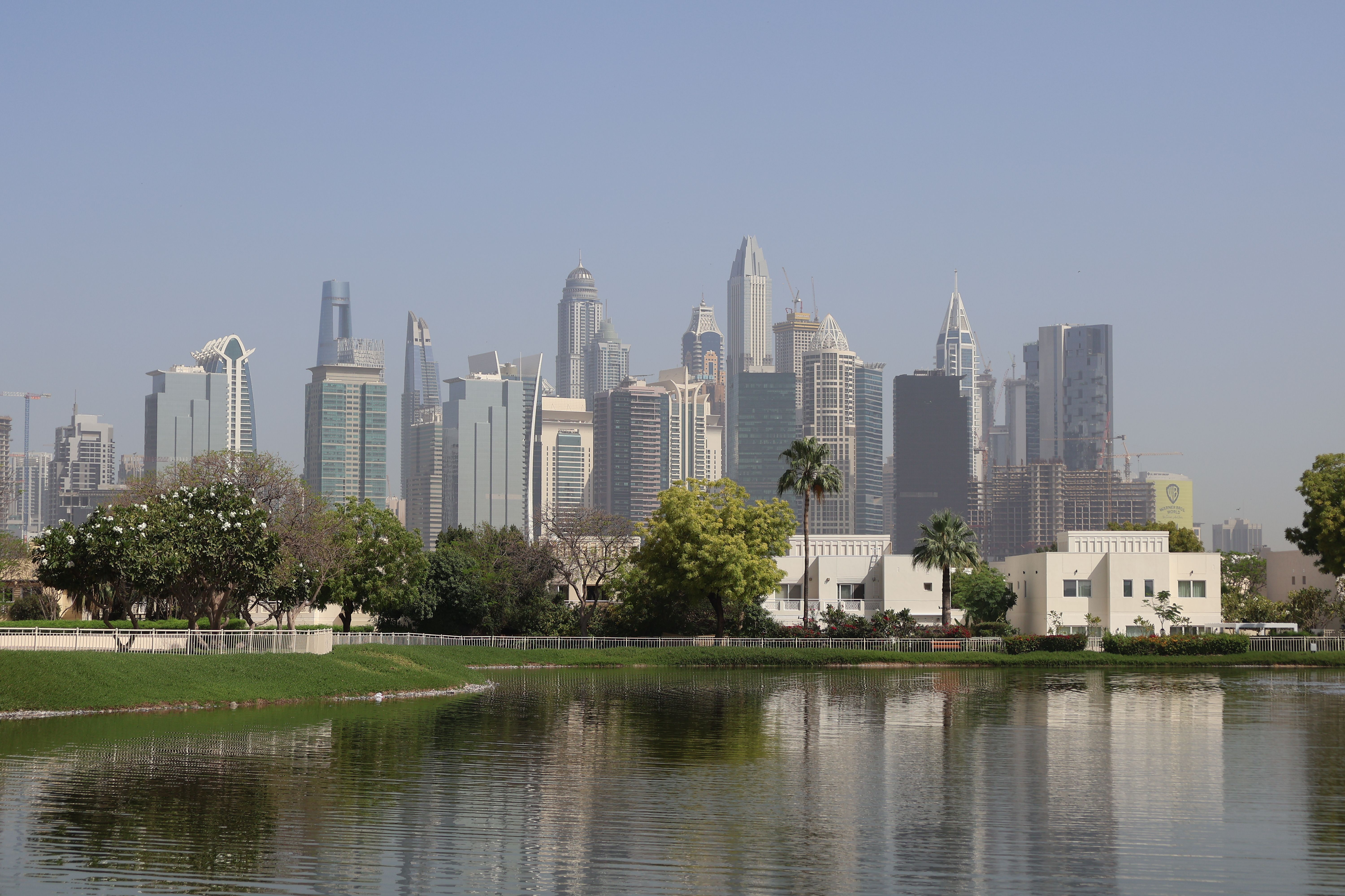 Dubai Skyline with Park and Water Reflection