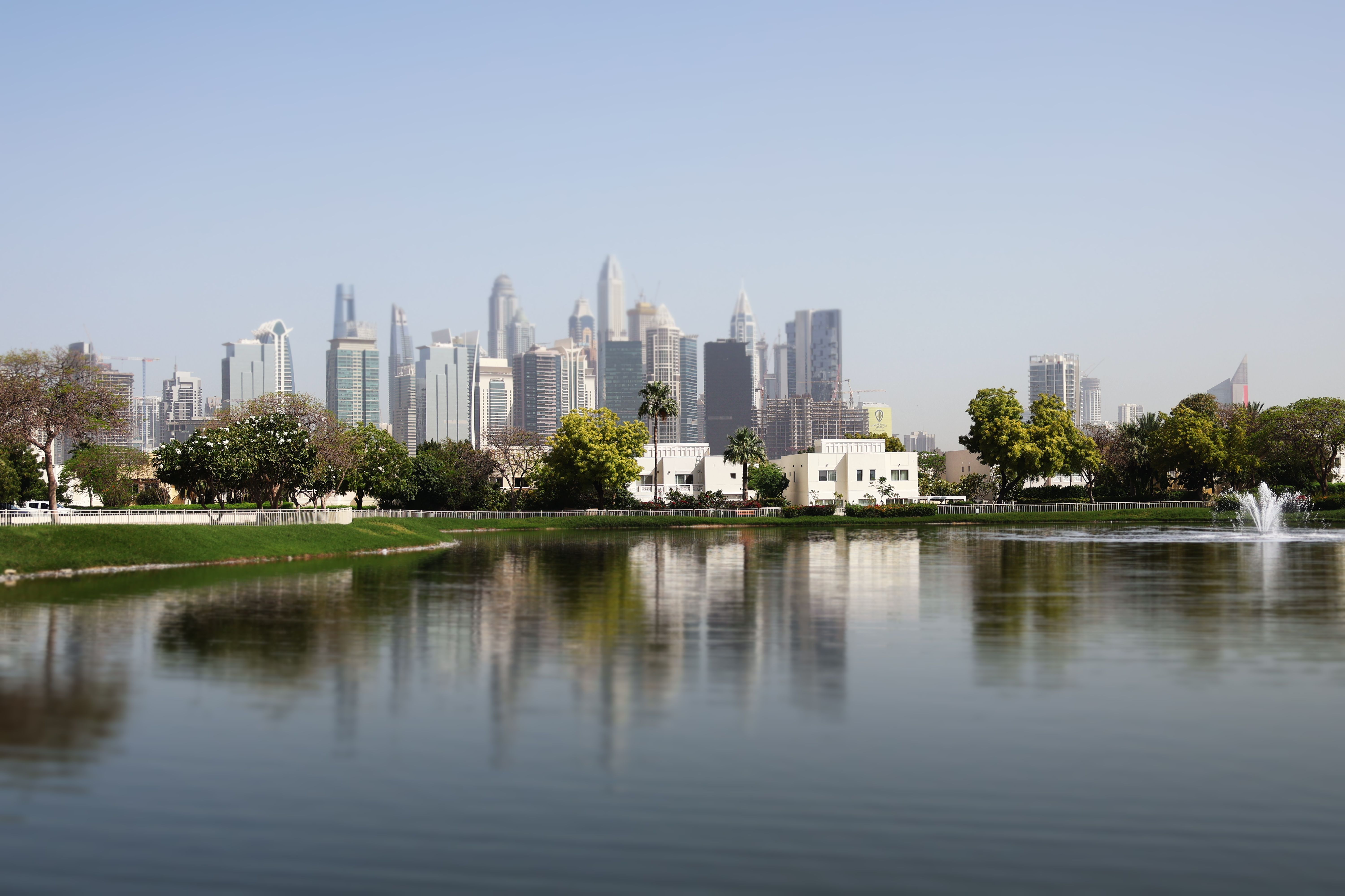 Modern Dubai Skyline Reflected on Tranquil Lake