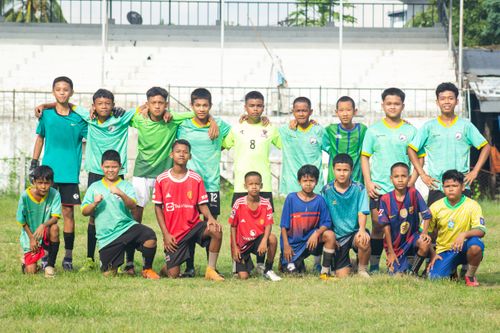 Free A group of young boys posing as a soccer team on a field in Myawaddy, Myanmar. Stock Photo