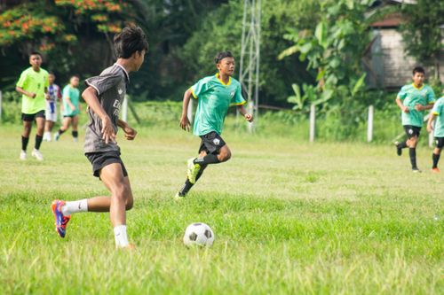 Free Energetic young players compete in a soccer match in lush Myawaddy, Myanmar. Stock Photo