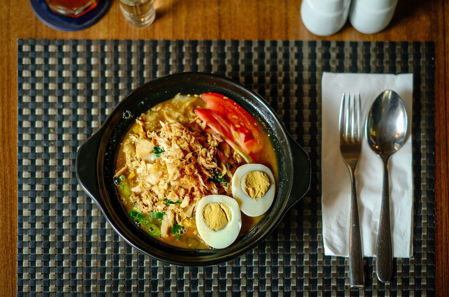 Authentic Indonesian noodle soup with boiled eggs, tomatoes, and spices in Jakarta.