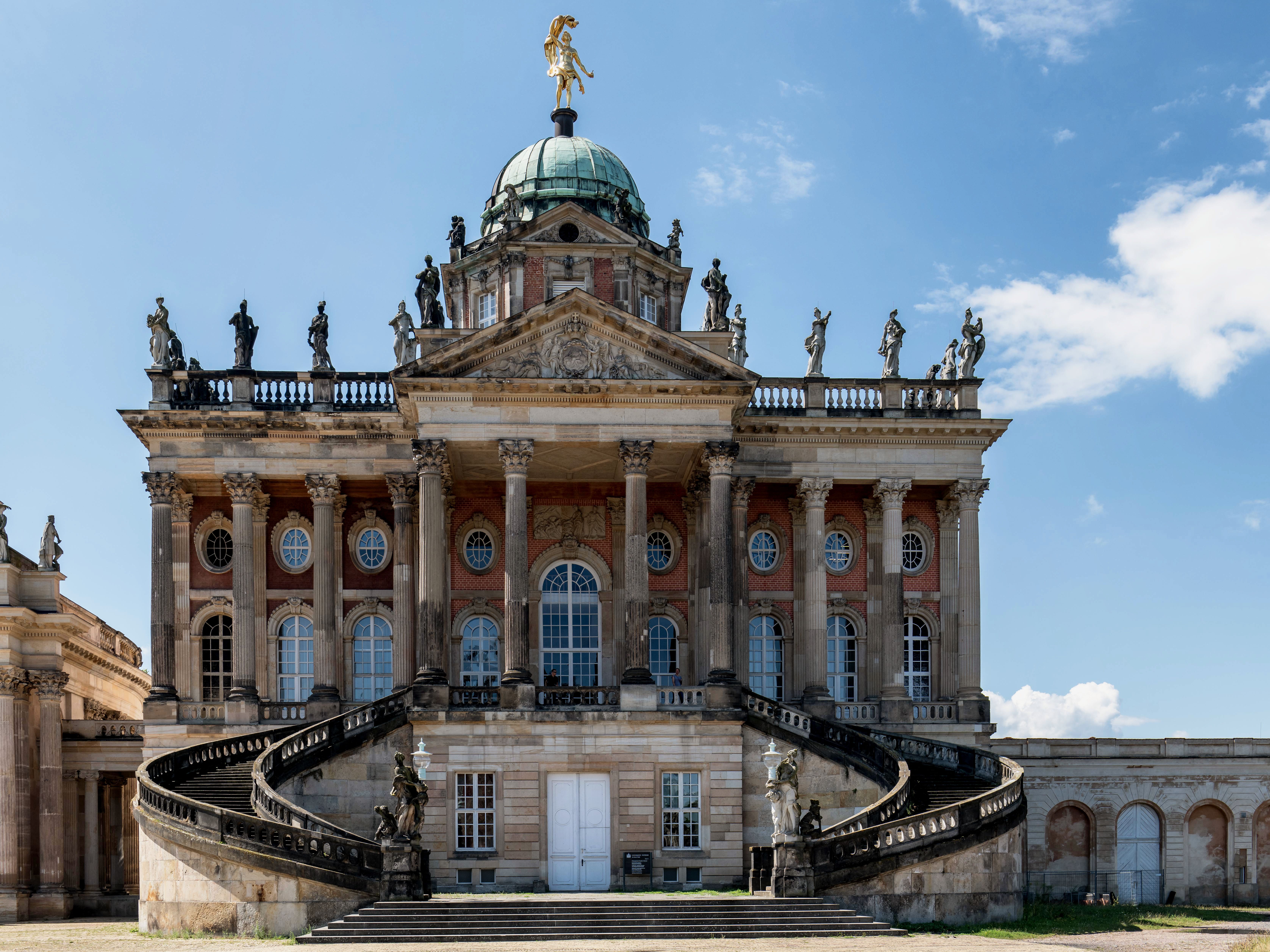 Captivating front view of Sanssouci Palace showcasing its stunning Baroque architecture under a bright sky.