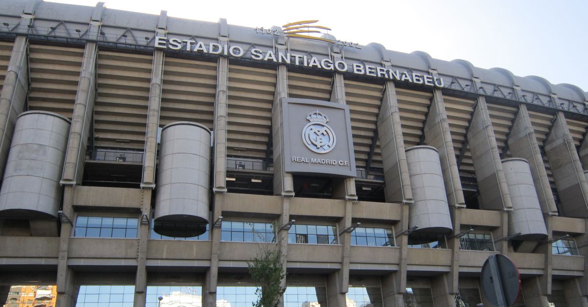 Impressive view of the iconic Santiago Bernabéu Stadium in Madrid, Spain, captured during a bright summer day.