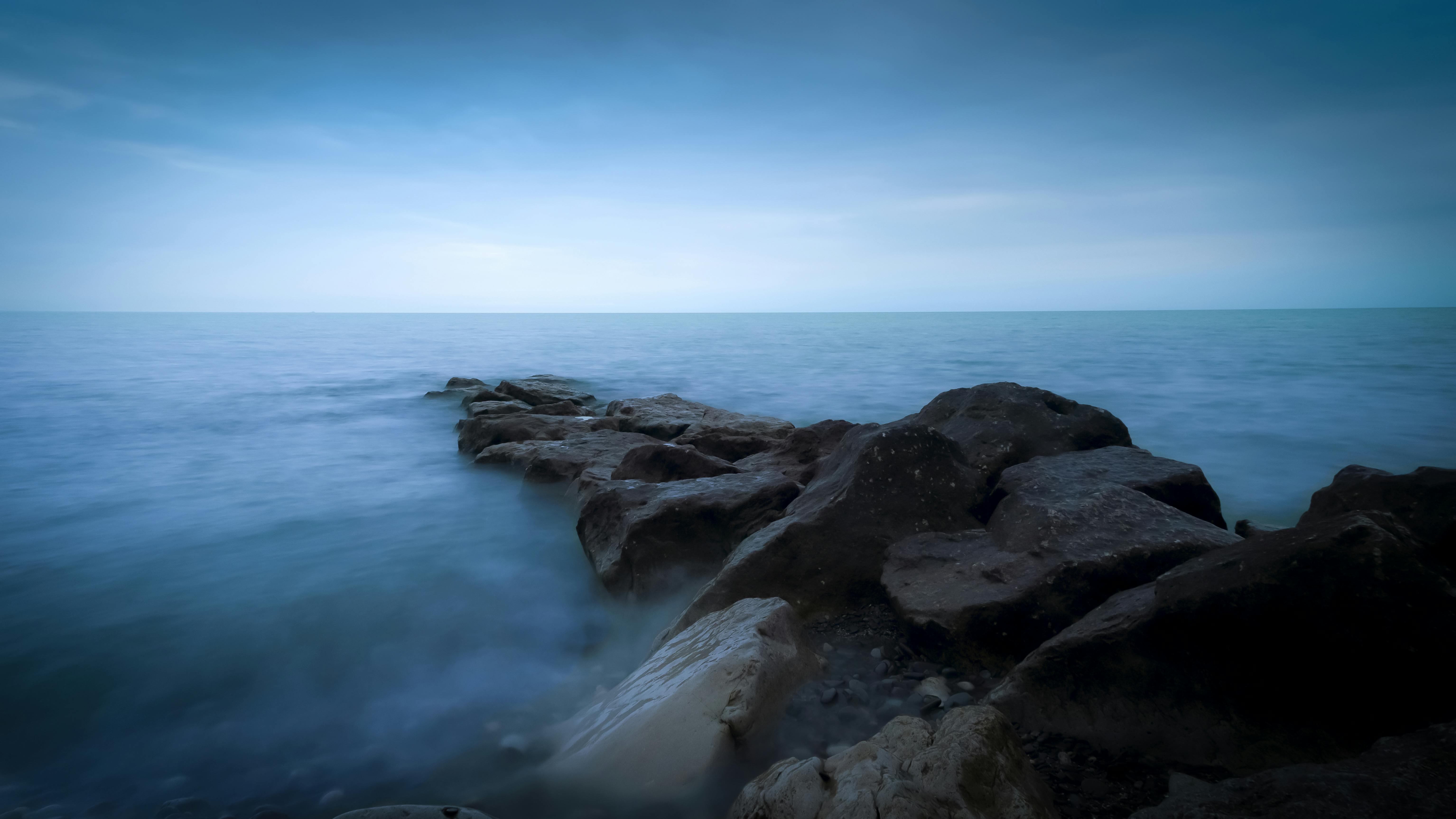 rocky shore under blue sky