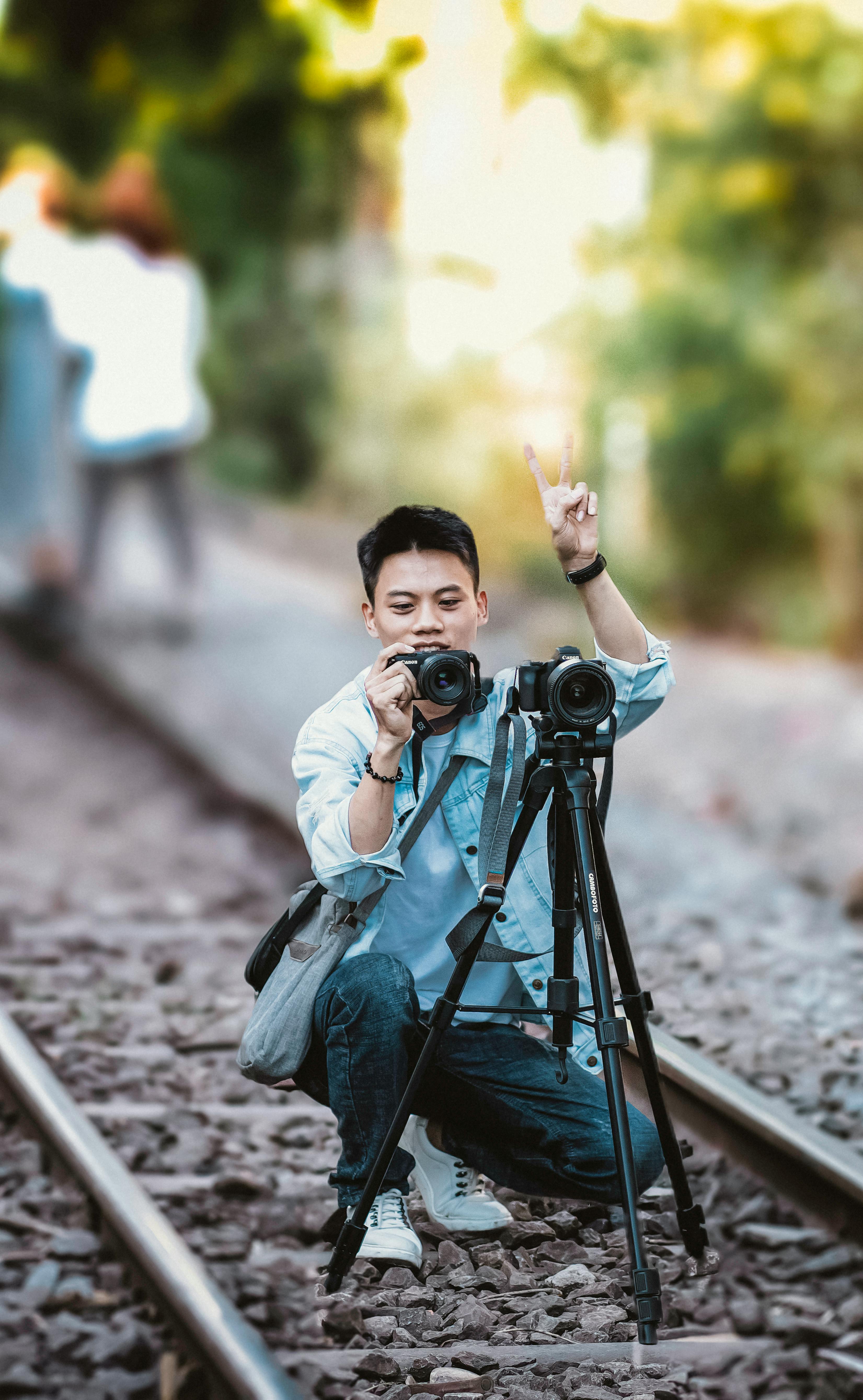 Man with Camera Checking Pictures · Free Stock Photo