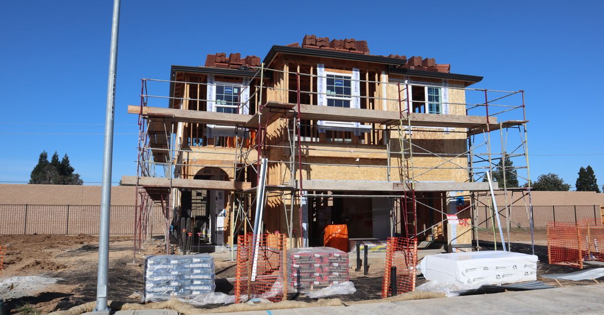 Construction site of a new home development in Elk Grove, California, showcasing scaffolding and materials.