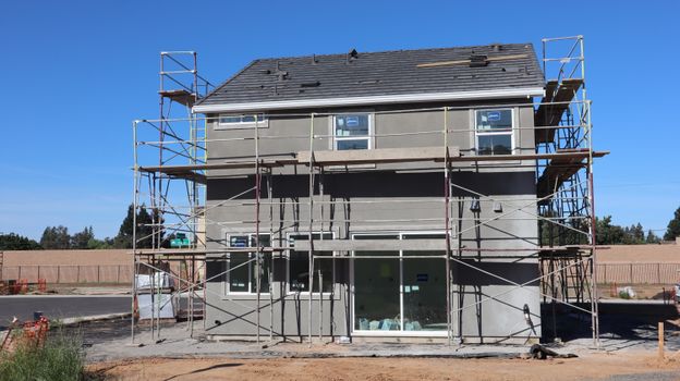 Scaffolding surrounds a new home under construction in Elk Grove, California.