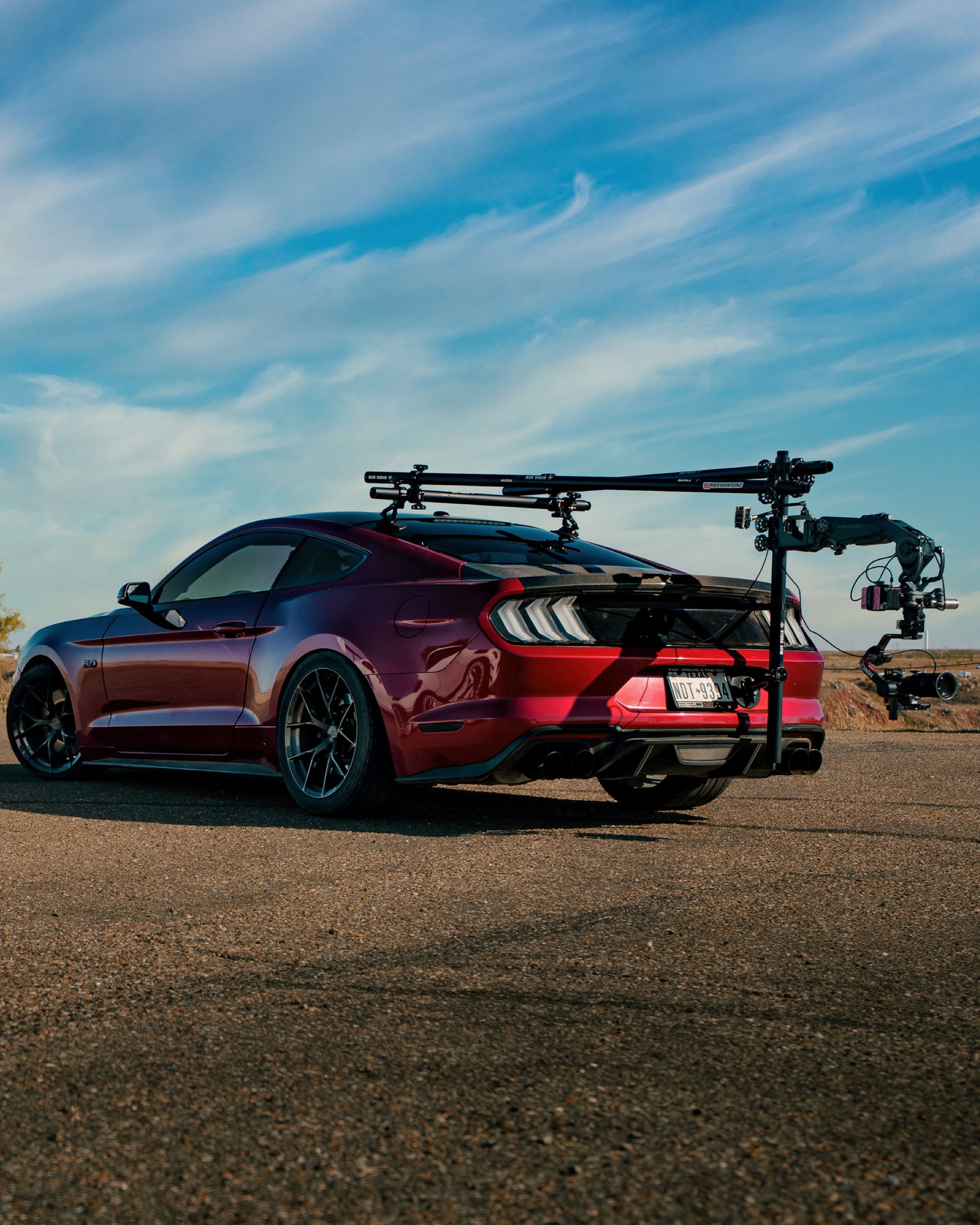 Red Sports Car with Mounted Camera Rig on Open Road · Free Stock Photo