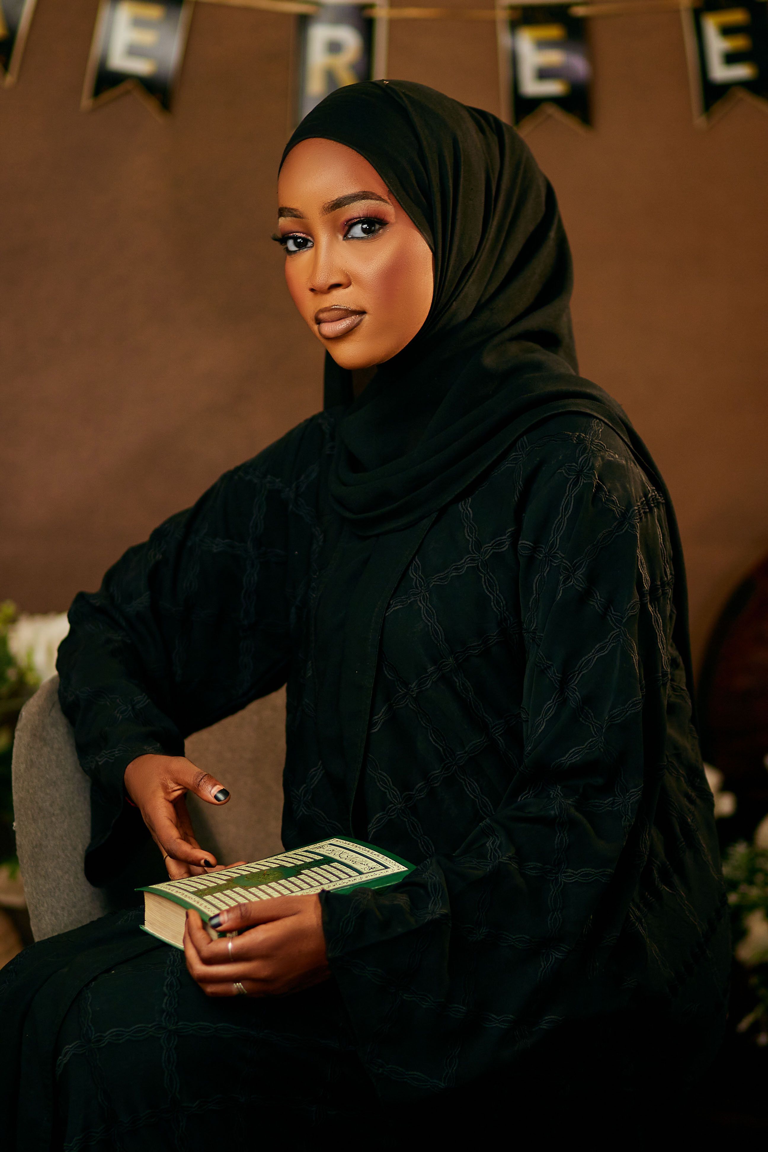 Young Woman in Black Hijab Holding Book · Free Stock Photo