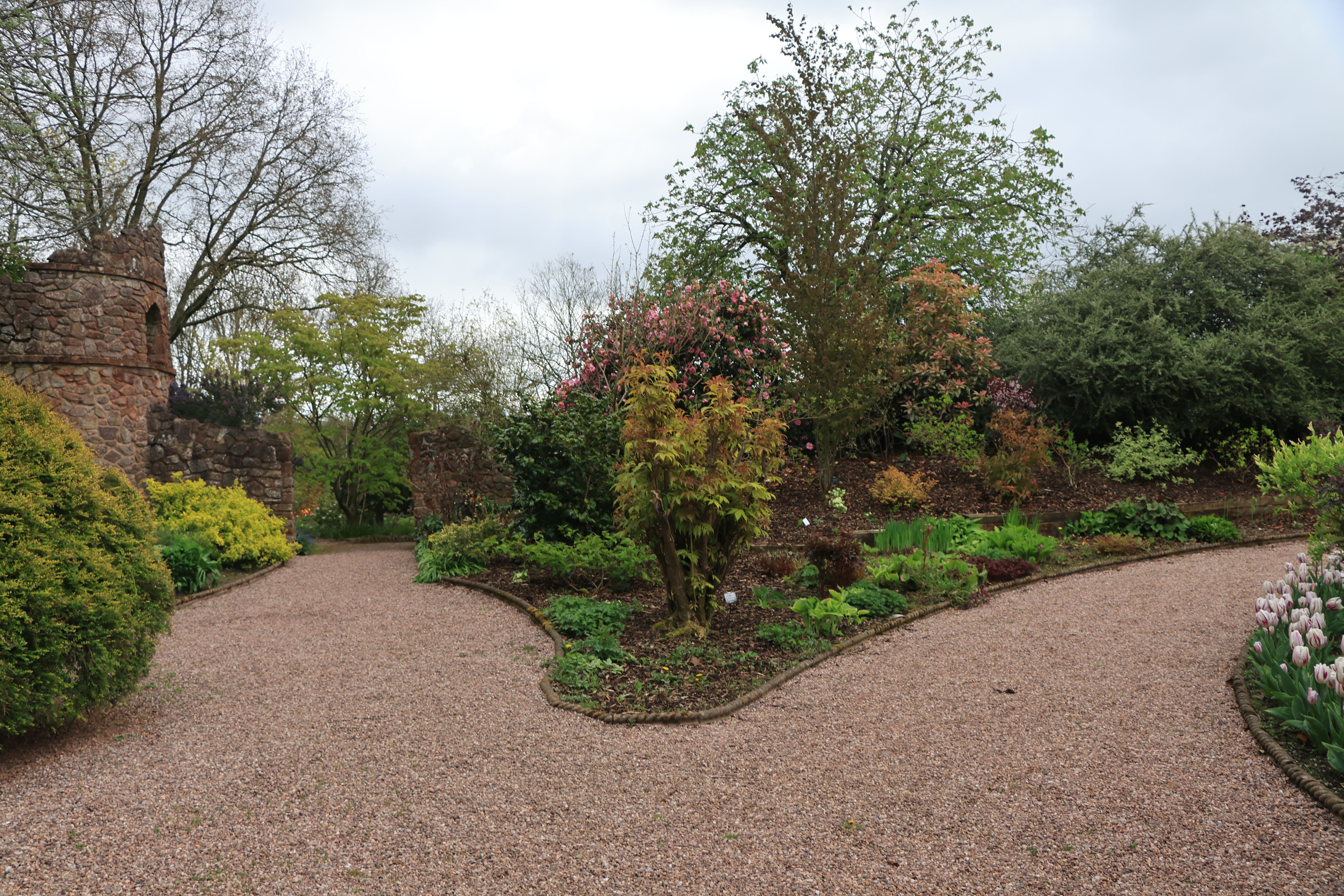 Permeable weed mat laid under gravel path in UK garden