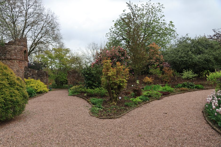 Curved gravel pathways connecting separated garden room areas Curved gravel pathways connecting separated garden room areas