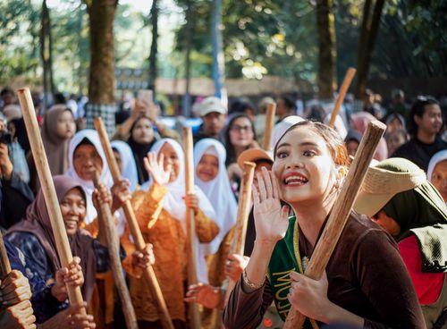 Free Engaging street scene of a traditional dance festival with women in Purwakarta, Indonesia. Stock Photo