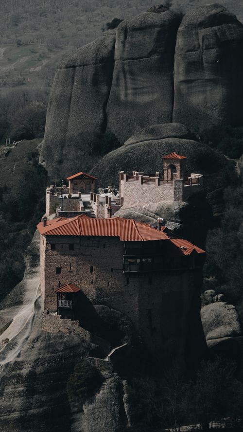 Free A stunning aerial view of a historic monastery built on sheer rock formations. Stock Photo