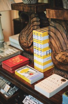 A cozy display of art and travel books on elegant wooden furniture in a Greenville boutique.