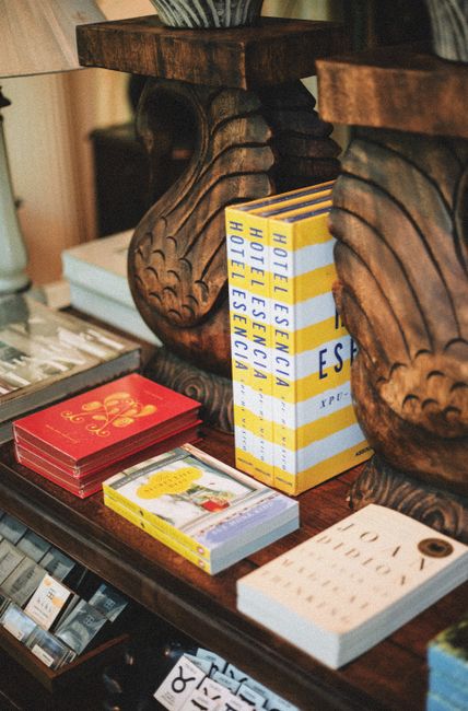 A cozy display of art and travel books on elegant wooden furniture in a Greenville boutique.