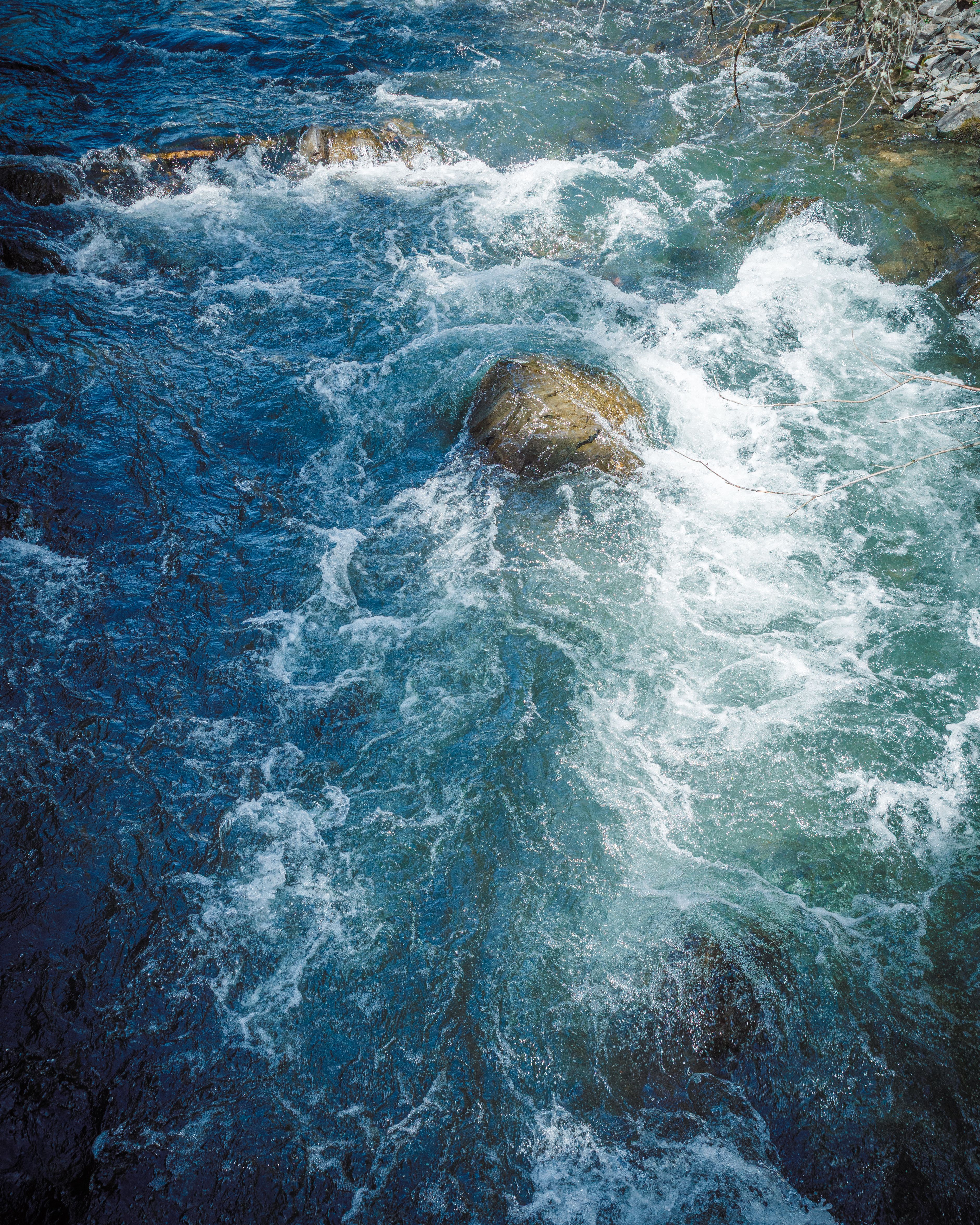 Relaxing view of a gentle river flow over stones in Sichuan, China.