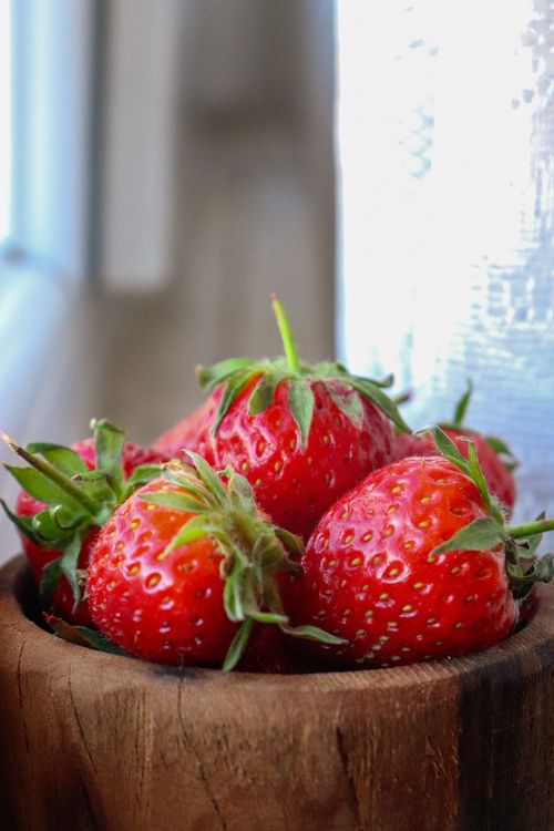 Free Bright and fresh strawberries in a wooden bowl. Perfect for food and health themes. Stock Photo