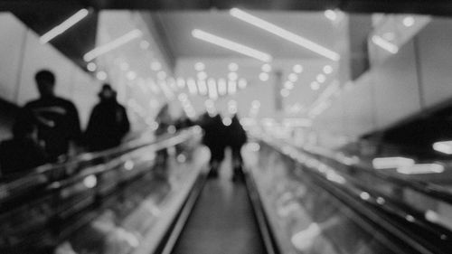Free Abstract blurred image of people on an escalator in a subway station. Stock Photo