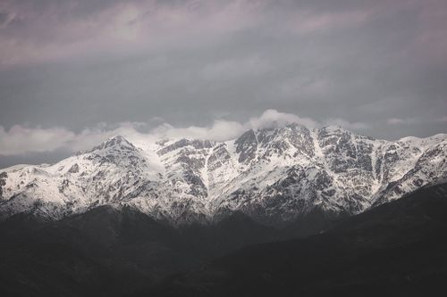 Free Striking photo of snow-covered mountains with dramatic sky, invoking a sense of awe and natural beauty. Stock Photo
