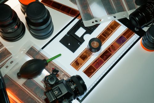 Free Studio shot showcasing professional film photography equipment including lenses, negatives, and inspection tools. Stock Photo