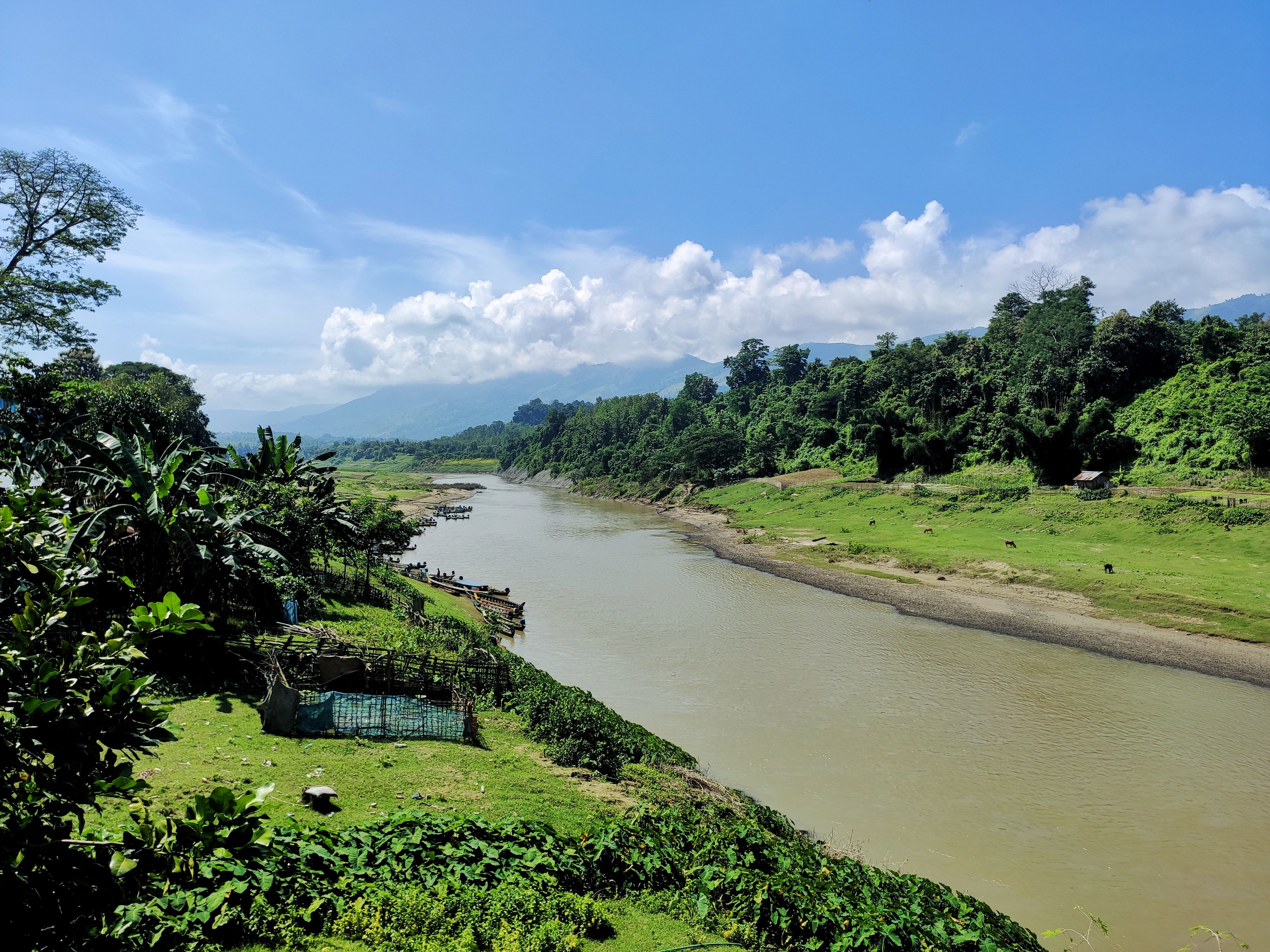 Scenic Riverside Landscape with Green Hills · Free Stock Photo