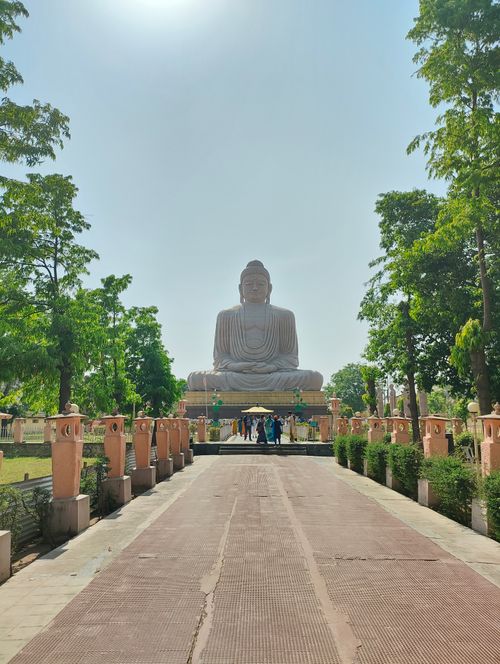 Free The Great Buddha statue surrounded by lush greenery in Bodh Gaya, India. Stock Photo