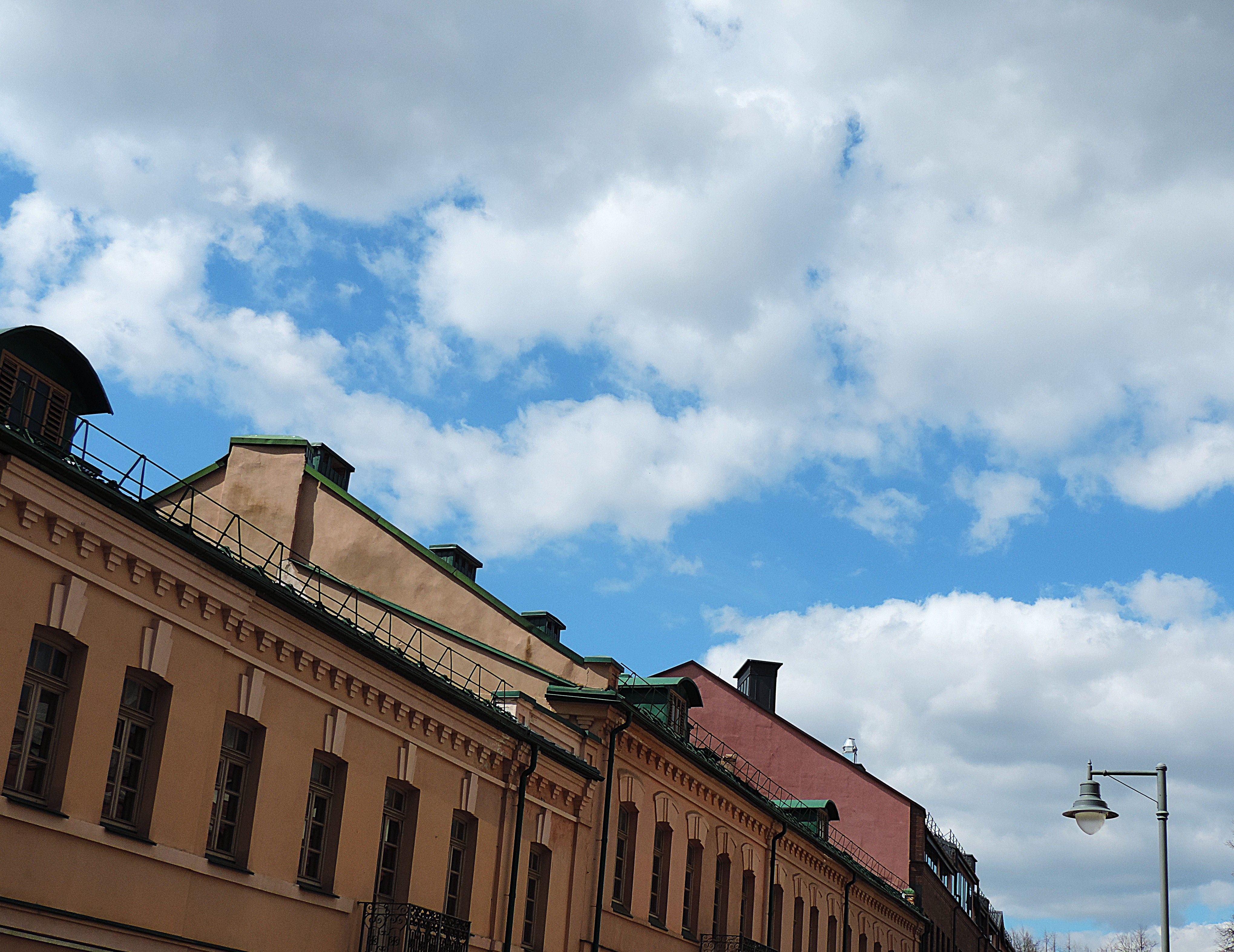 Historic European Rooftops and Cloudy Sky · Free Stock Photo