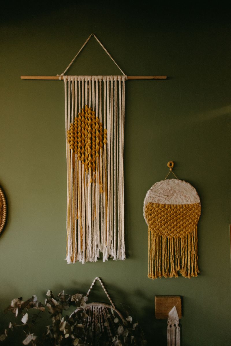 Bohemian macramé wall hangings styled as a boho party backdrop