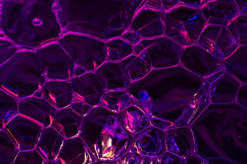 Free Artistic close-up of neon-toned soap bubbles with a magenta hue, captured in Valencia. Stock Photo