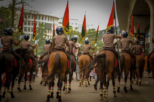 Free Mounted police parade in city street with colorful flags, creating a vibrant, organized display. Stock Photo