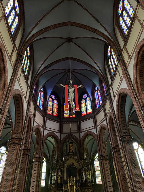 Free Breathtaking view of a Gothic church interior showcasing stained glass and arches. Stock Photo