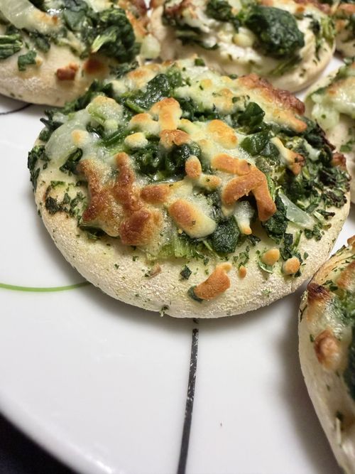Free Delicious homemade mini pizzas with fresh spinach and melted cheese on a white plate. Stock Photo