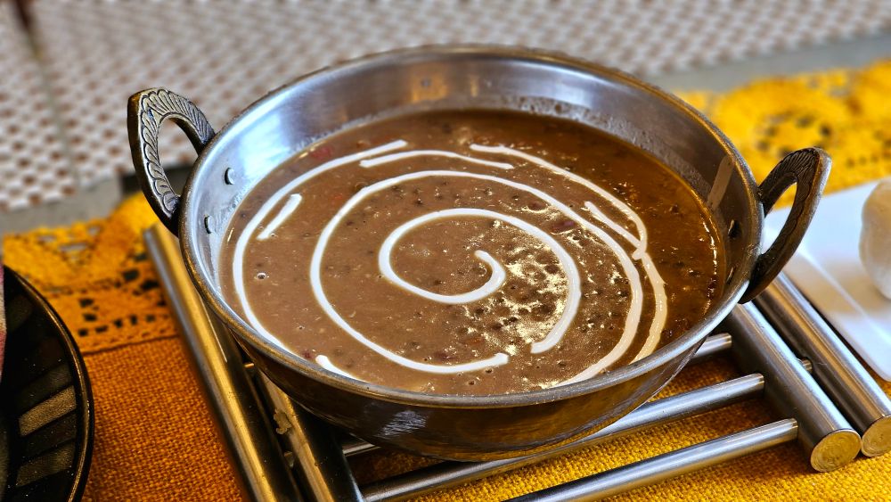 Creamy dal makhani garnished with cream