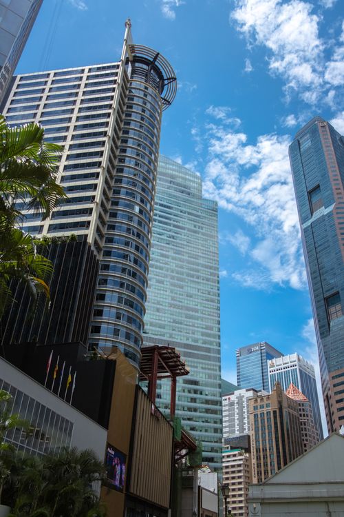 Free A vibrant cityscape showcasing Singapore's modern skyscrapers against a clear blue sky. Stock Photo