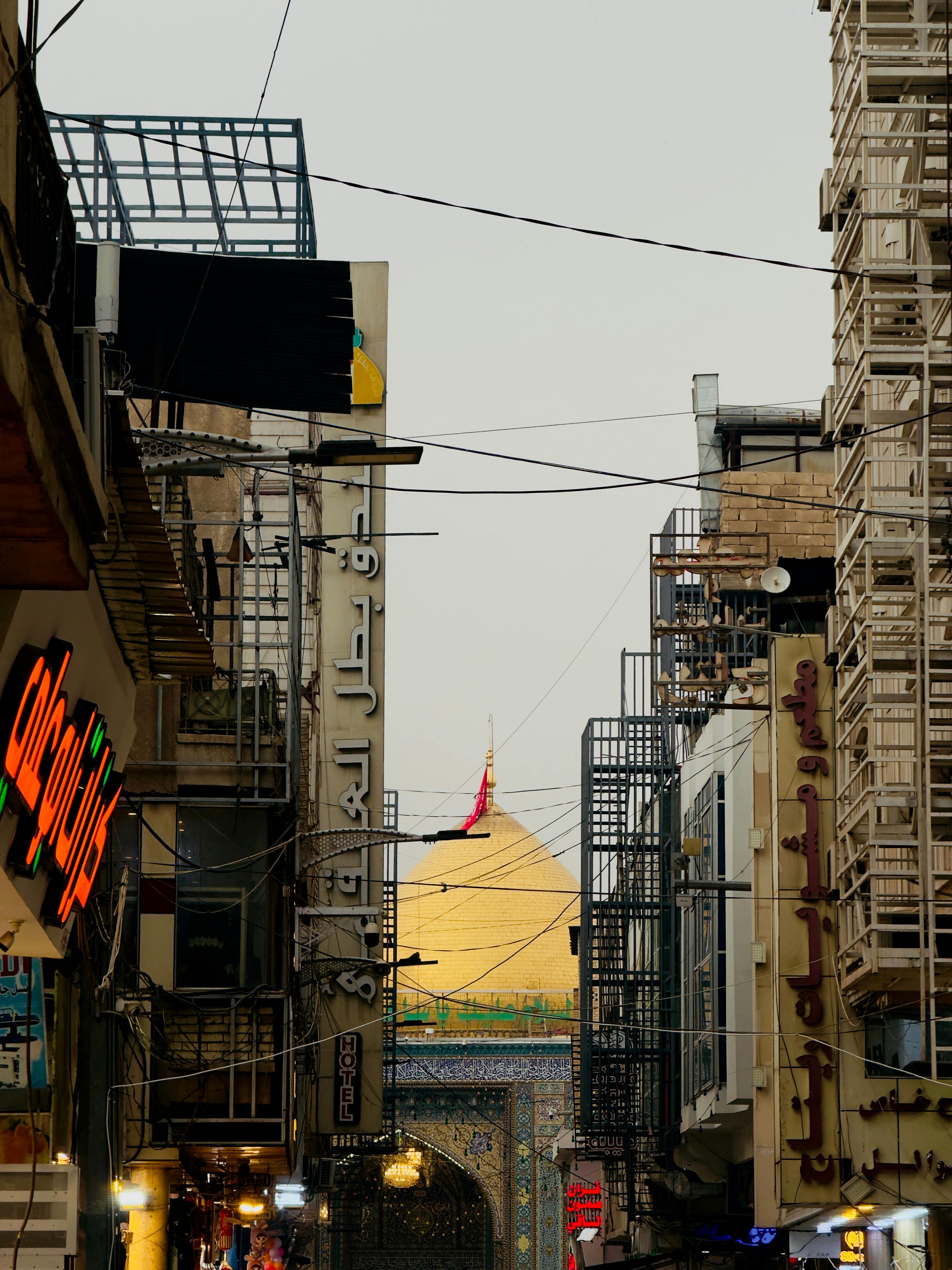 Bustling street view capturing a golden dome landmark framed by local shops and signage.