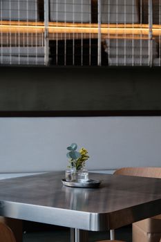 A modern cafe interior with a minimalist table setting and ambient lighting.