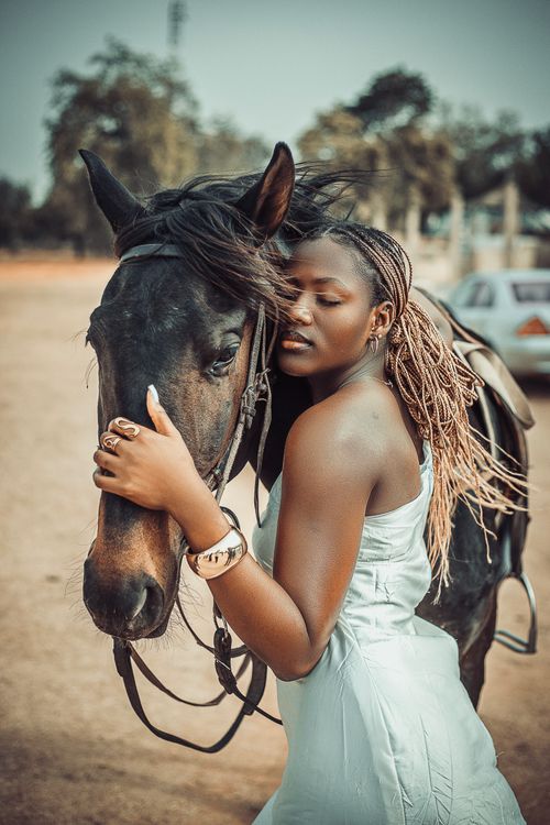 Free A graceful woman embraces a horse outdoors, radiating connection and tranquility. Stock Photo