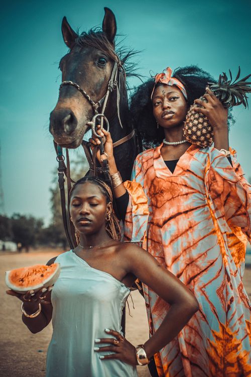 Free Vibrant African portrait showcasing tradition with a horse and tropical fruits outdoors. Stock Photo