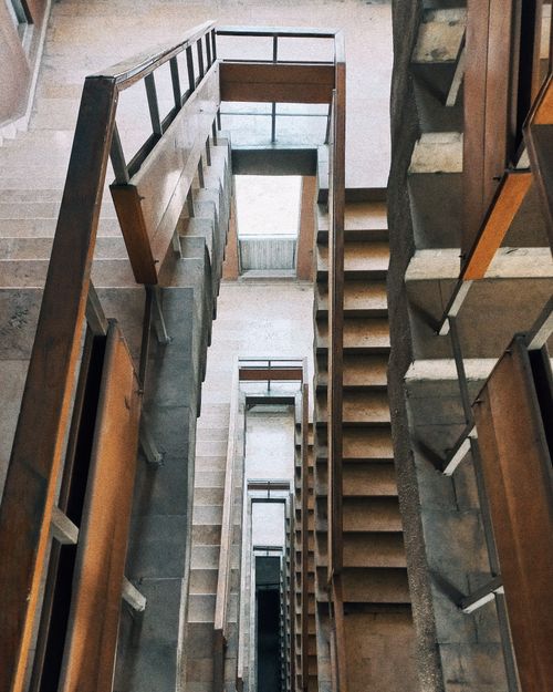 Free A detailed view of an abstract staircase featuring geometric patterns and concrete textures, offering an artistic architectural perspective. Stock Photo