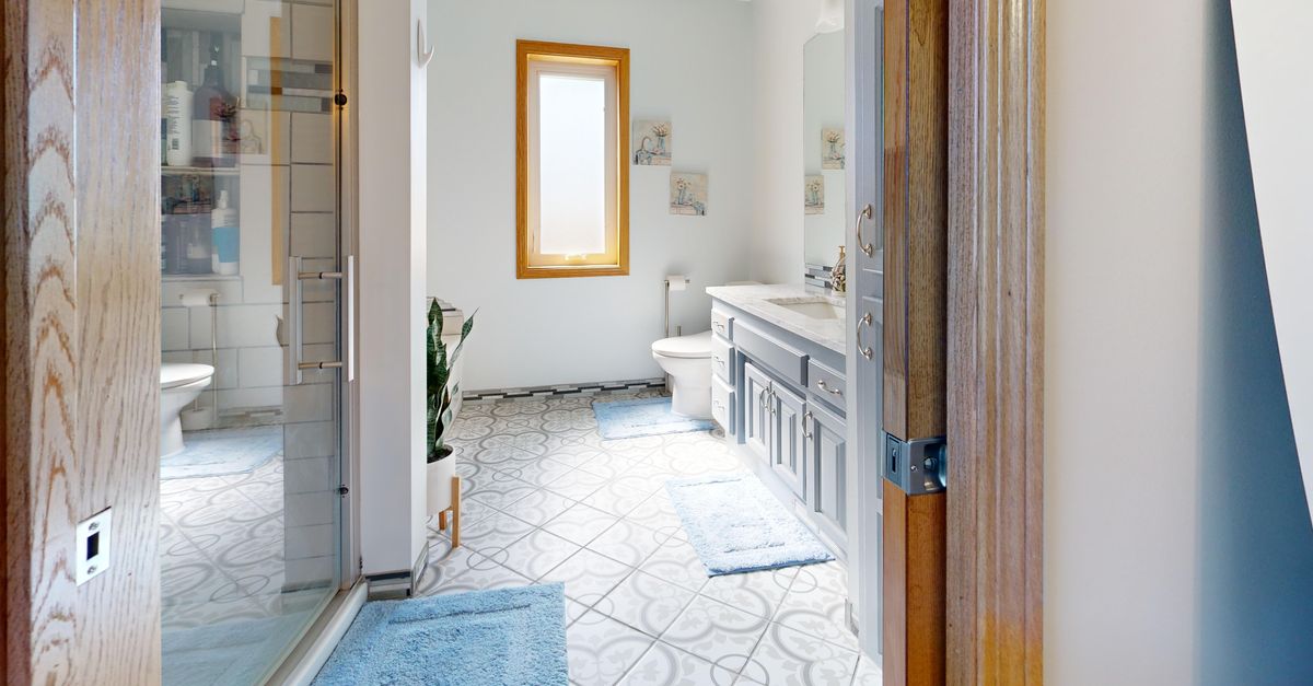 Bright modern bathroom featuring stylish decor and ample natural light.