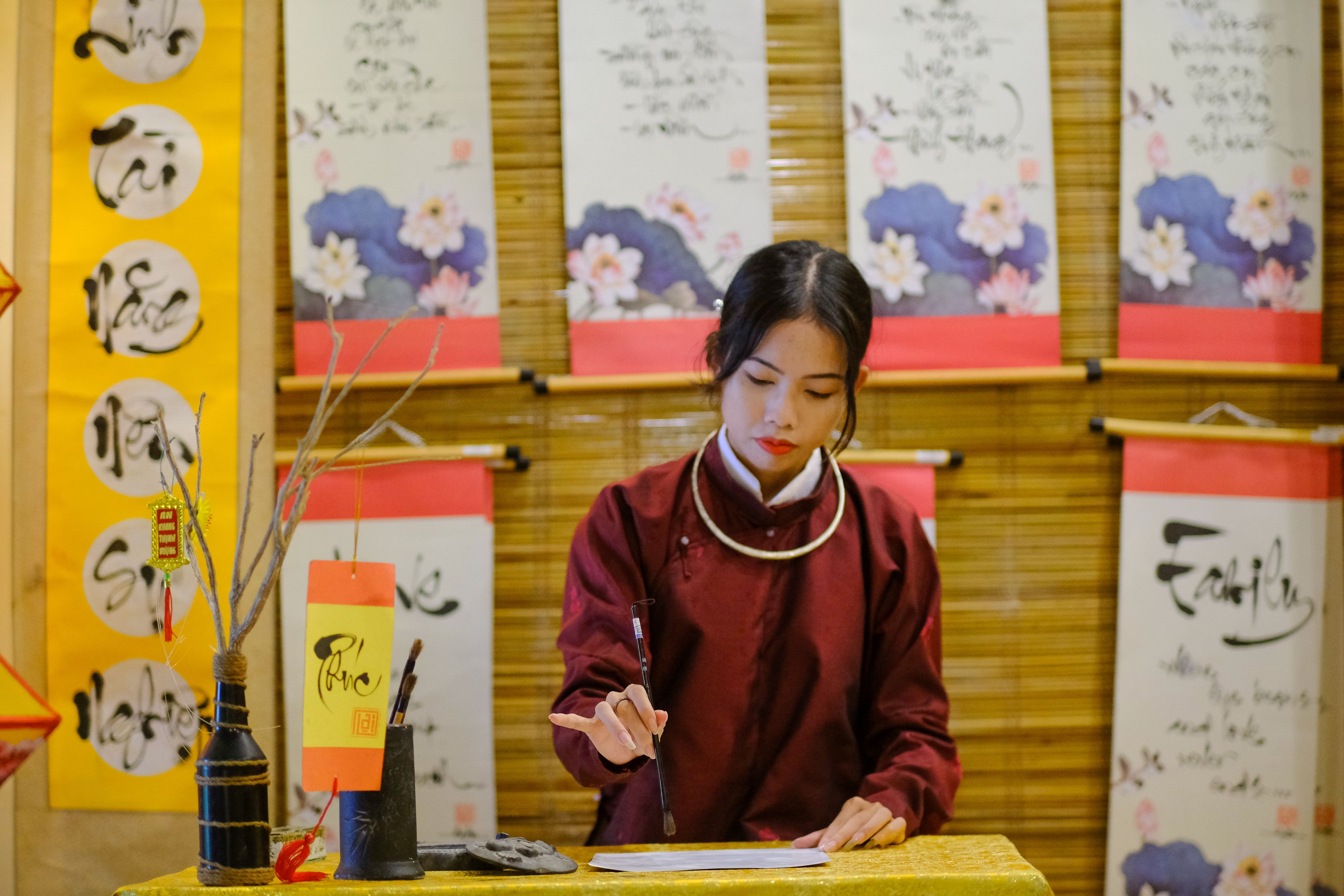 A Vietnamese calligraphy artist at work in Hue, showcasing traditional art and culture.